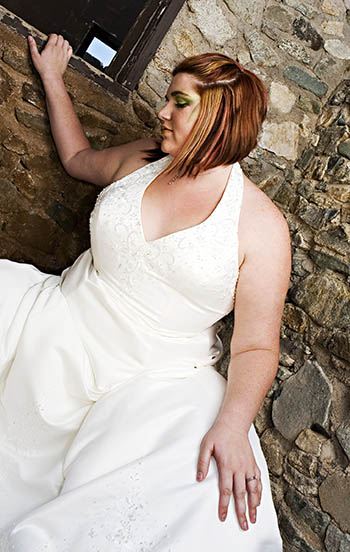 Beautiful plus size bride posing in wedding dress